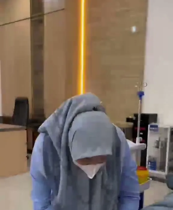 Perawat memasang infus vitamin pada pasien yang berbaring di ruang tindakan